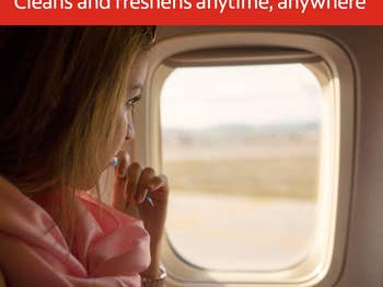 model using mini toothbrush while looking out a plane window