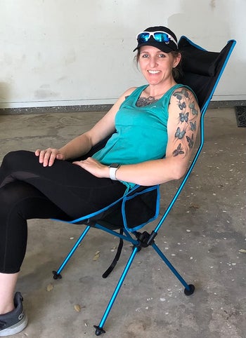 reviewer sitting in blue and black camping chair