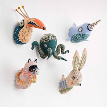 stuffed toucan, octopus, narwhal, bunny, and llama heads