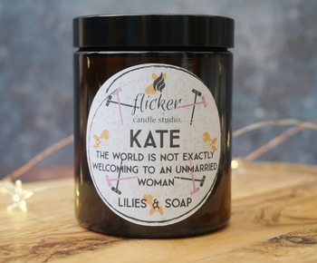 candle in brown jar with label printed with corgis and mallets and says kate and has the quote 