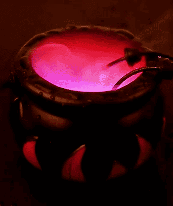 the black cauldron with red flames painted on the sides, bubbling and misting and changing colors from pink to red
