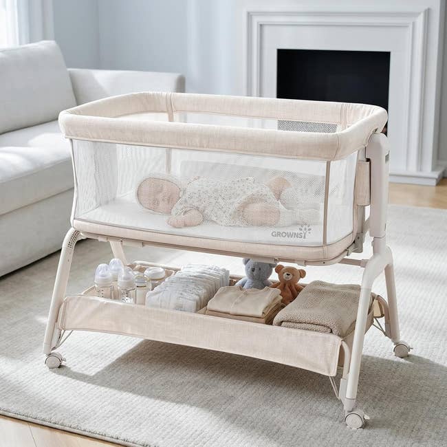 Baby sleeping successful a mesh bassinet with retention below, featuring folded blankets, bottles, and a stuffed artifact successful a cozy surviving country setting