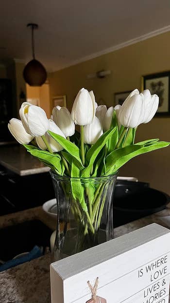 A bunch of the white tulips in a glass vase