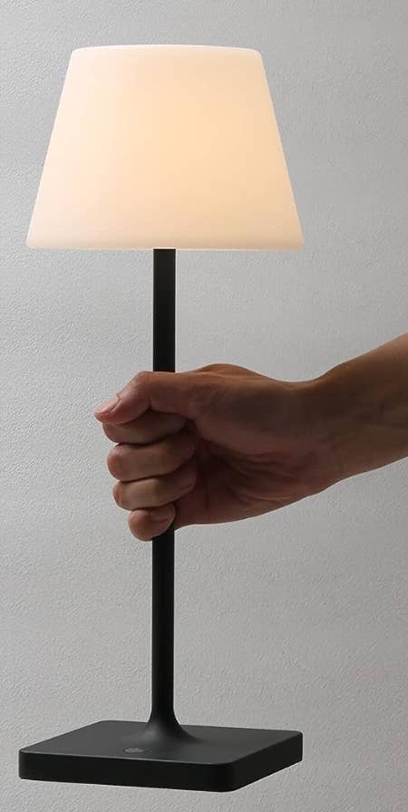 a model holding the cordless lamp