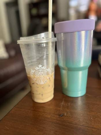 reviewer's iced coffee next to the ombre blue and purple sleeve
