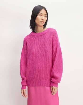 a model in a pink oversized sweater