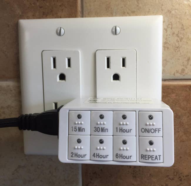 rectangle shaped outlet with bu ttons ranging from 15 minutes to six hours, plus an on/off and repeat button plugged in a reviewer's outlet