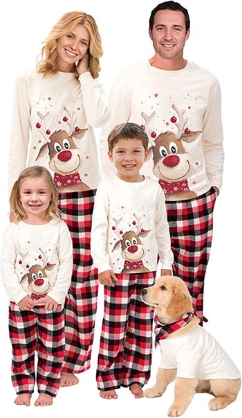 a family in buffalo print pajama pants and long sleeves cream shirts with a reindeer on it