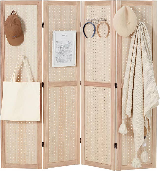 tan divider with bags, scarves, and accessories hung on it