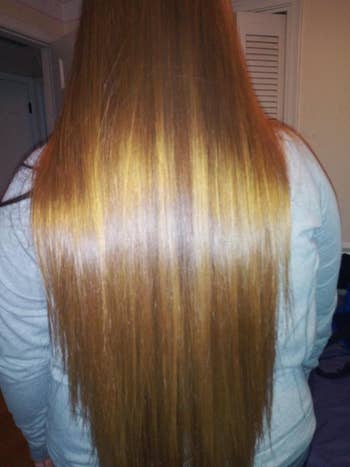 A idiosyncratic   with long, consecutive  hairsbreadth  shown from the back, wearing a airy  top