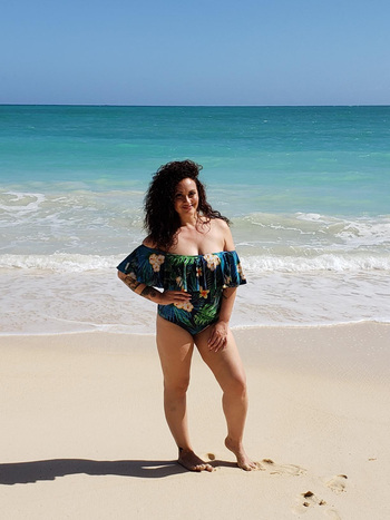 reviewer wearing the ruffle-topped swimsuit in green