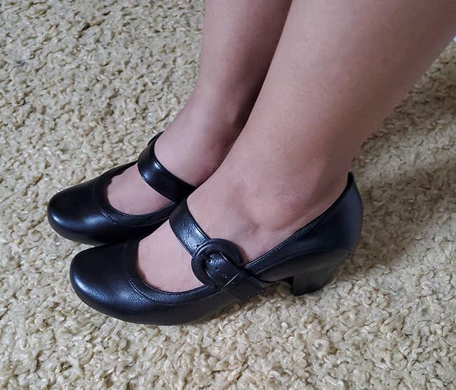 a reviewer wearing the mary jane pumps in black 
