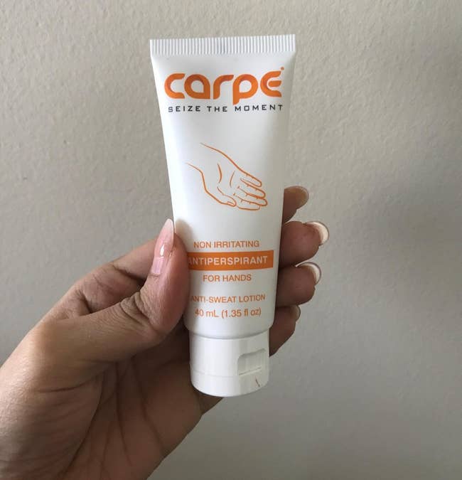 reviewer holding the conduit of manus cream
