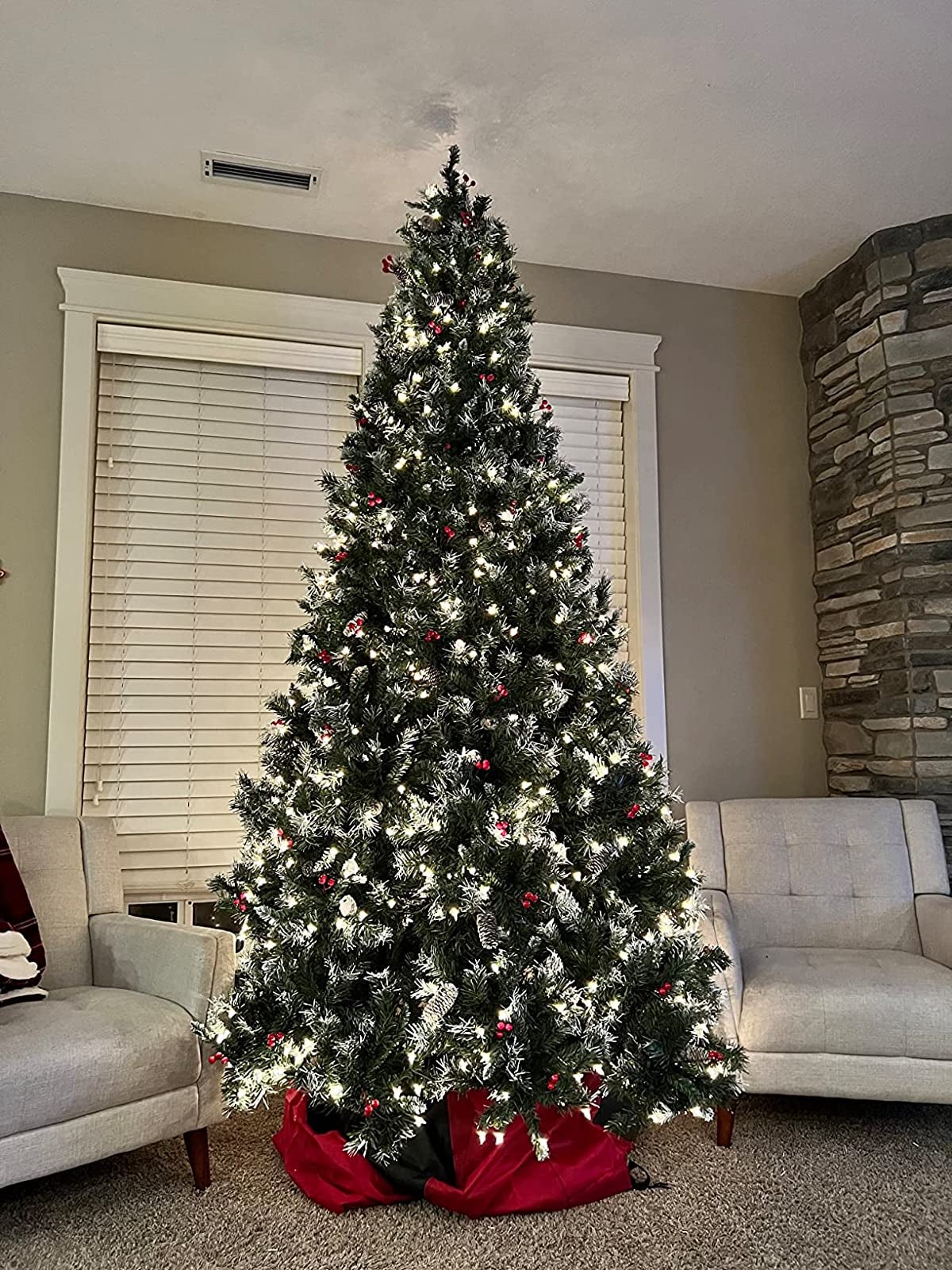 reviewer image of the pre-lit artificial christmas tree in a living room