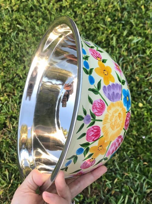 side view of reviewer holding the hand painted bowl
