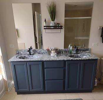 the same reviewer's bathroom vanity looking more modern with the granite peel and stick and a new paint color