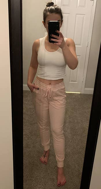 Image of reviewer wearing light pink joggers
