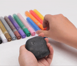 gif of person drawing narwhale on rock