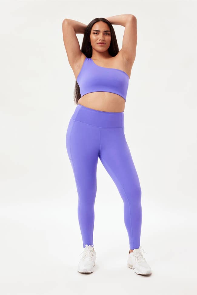 a model in bright purple leggings