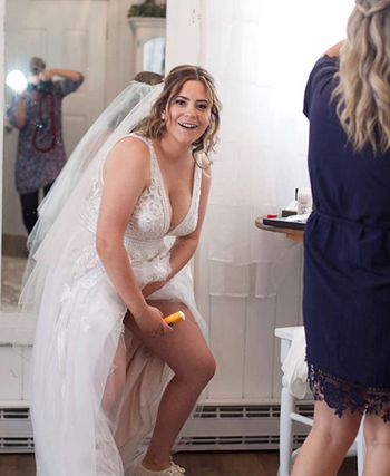 bride using the gold bond stick under their wedding dress