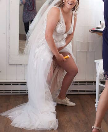 bride using the gold bond stick under their wedding dress