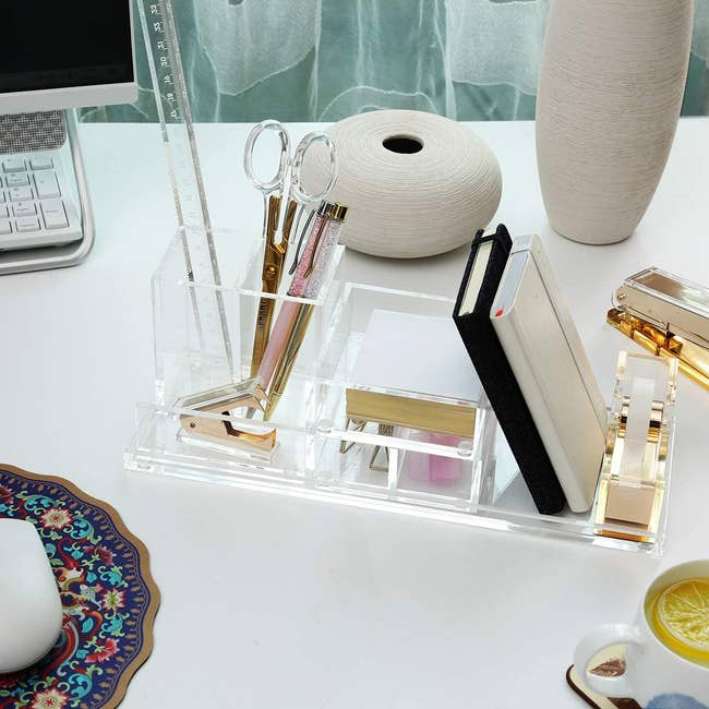 the clear organizer with office supplies inside