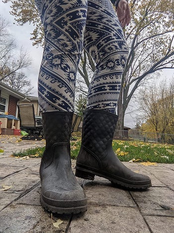 a reviewer in the black rain boots with the quilted pattern