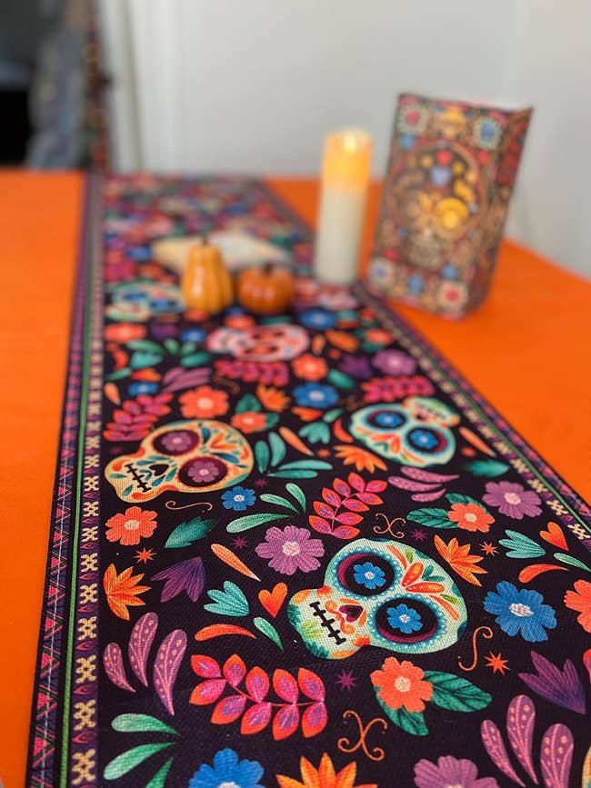 reviewers table with colorful cloth table runner with sugar skulls and flower designs 