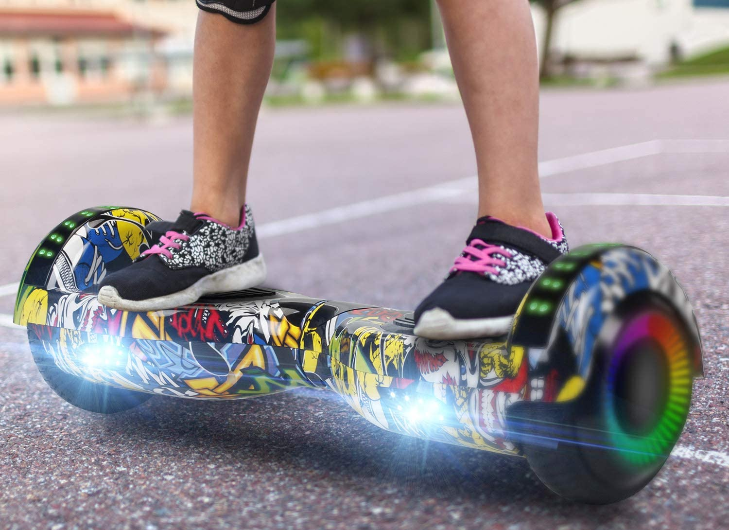 Model standing on multi-colored hoverboard outside