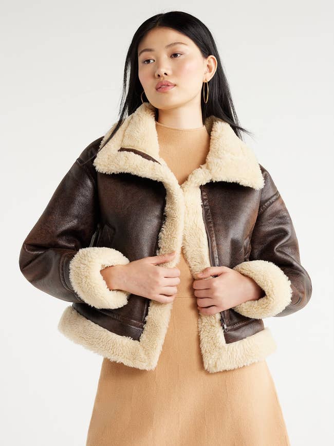 model wearing brown faux suede bomber jacket with faux sherpa lining