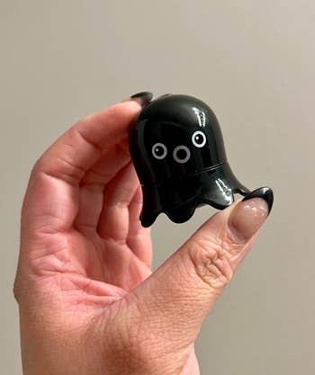 black small octopus-shaped blackhead remover in an editor's hand