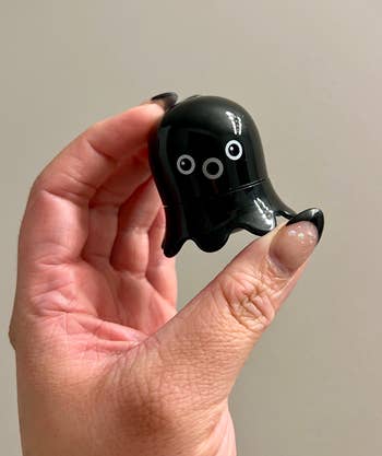 black small octopus-shaped blackhead remover in an editor's hand