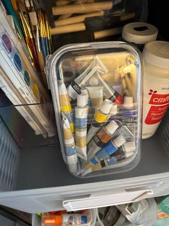 Art supplies, including overgarment tubes successful a integrative case