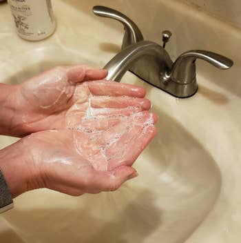 reviewer with soapy hands after paper dissolved in warm water