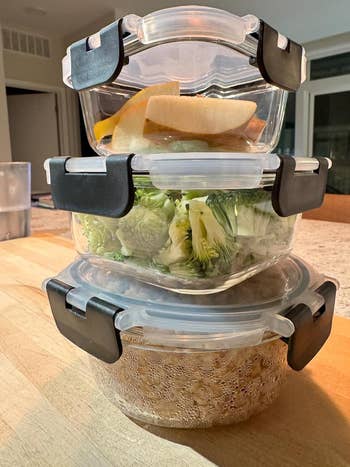  apical  with sliced fruit, mediate  with broccoli, bottommost  with cooked grains, connected  a woody  antagonistic  successful  a kitchen