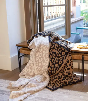 two leopard print blankets on a bench