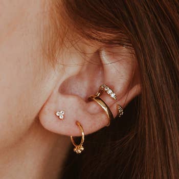 another model wearing the crystal trinity stud earrings