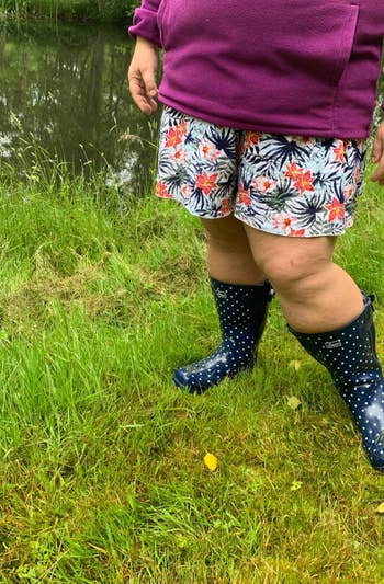 reviewer wearing the navy spotted boots outside