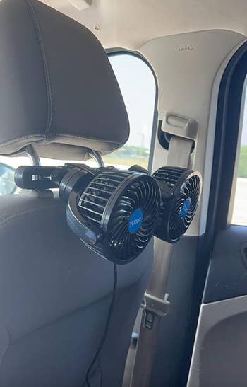 reviewer's portable dual-fan unit attached to the back of a car seat
