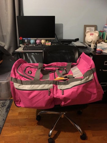 reviewer photo of the bright pink duffel bag