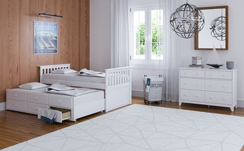 white trundle bed with drawers in a bedroom