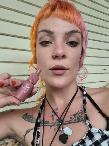 reviewer selfie holding mauve lip stain