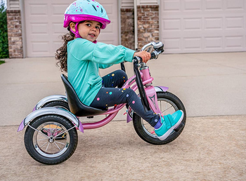 Child model riding pink trike