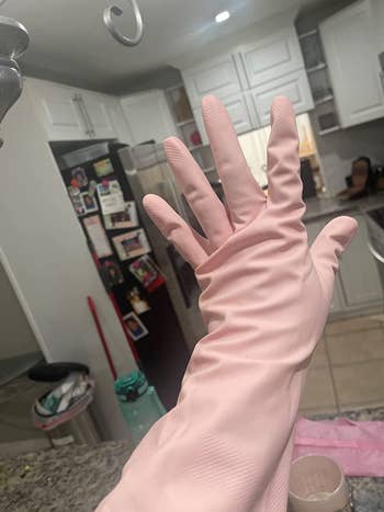 a reviewer wearing light pink rubber gloves