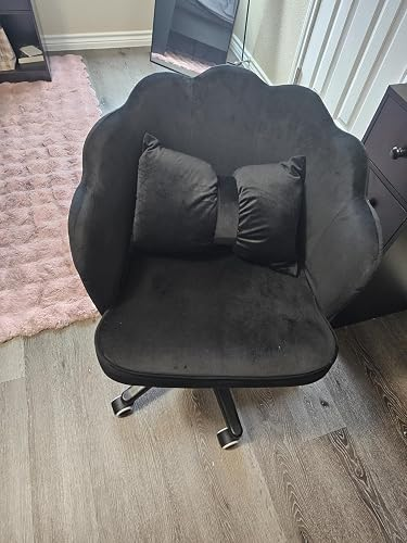 Plush, petal-shaped black chair with a matching bow-shaped cushion, perfect for a stylish home office or vanity setup