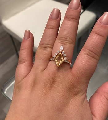 Hand wearing the rose gold cocktail ring set