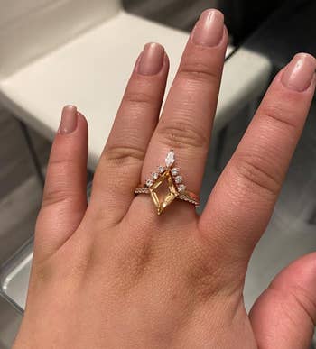 Hand wearing the rose gold cocktail ring set