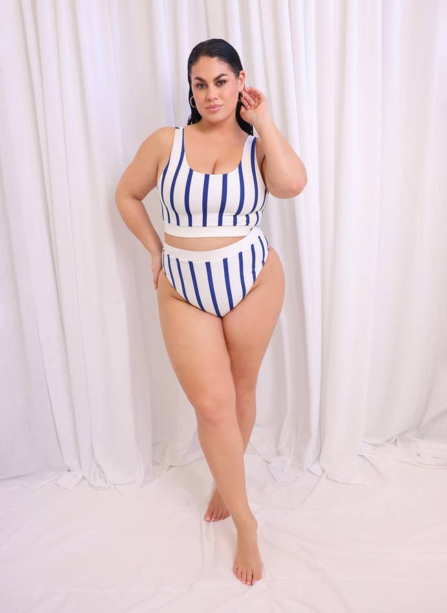 model in cropped tank-like top and high cut bottoms in white with vertical blue stripes
