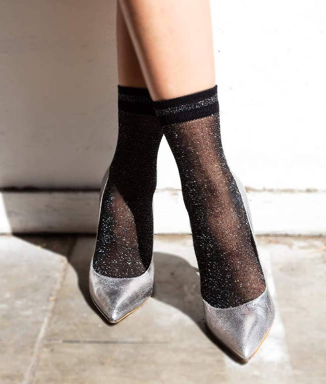 the socks on a model's feet with silver metallic heels