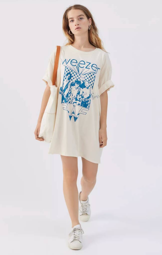 model wearing weezer t-shirt dress with sneakers